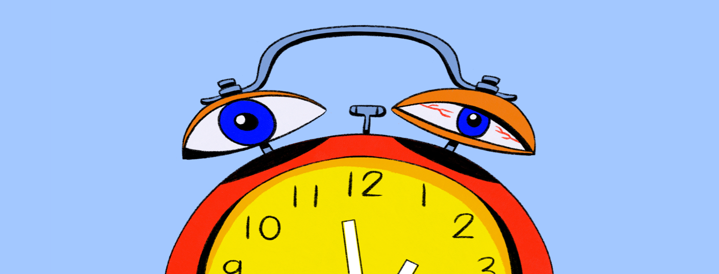 An alarm clock with two eyes as the bells at the top, one of them is red and dry.